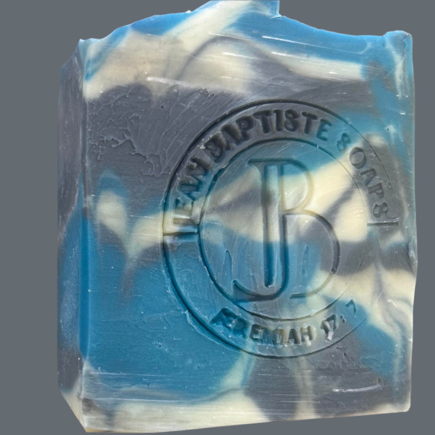 Blue and white soap bar with a brand logo on a beige background