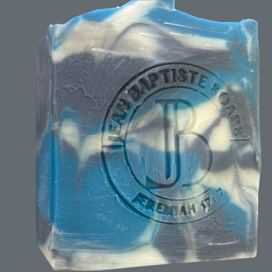Blue and white soap bar with a brand logo on a beige background